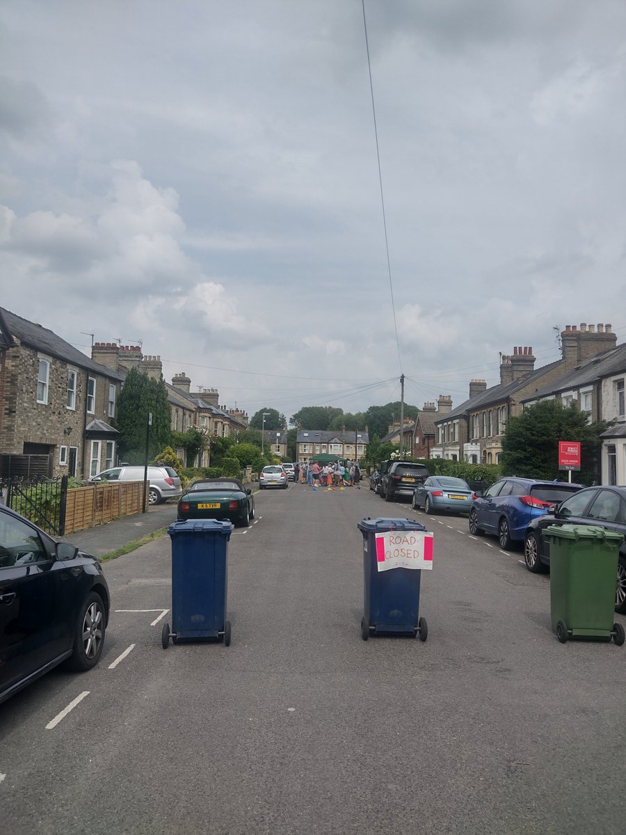 Love the simplicity of how traffic is restricted to create this street closure. A bin and a hand made sign is all it needs to create a community space for child's play and a party. Regent Street, Cambridge. 
@playingout