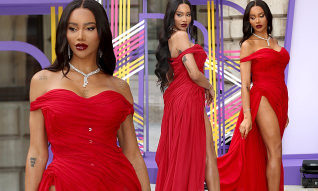 Transgender model Munroe Bergdorf put on a leggy display in a thigh-high split red dress