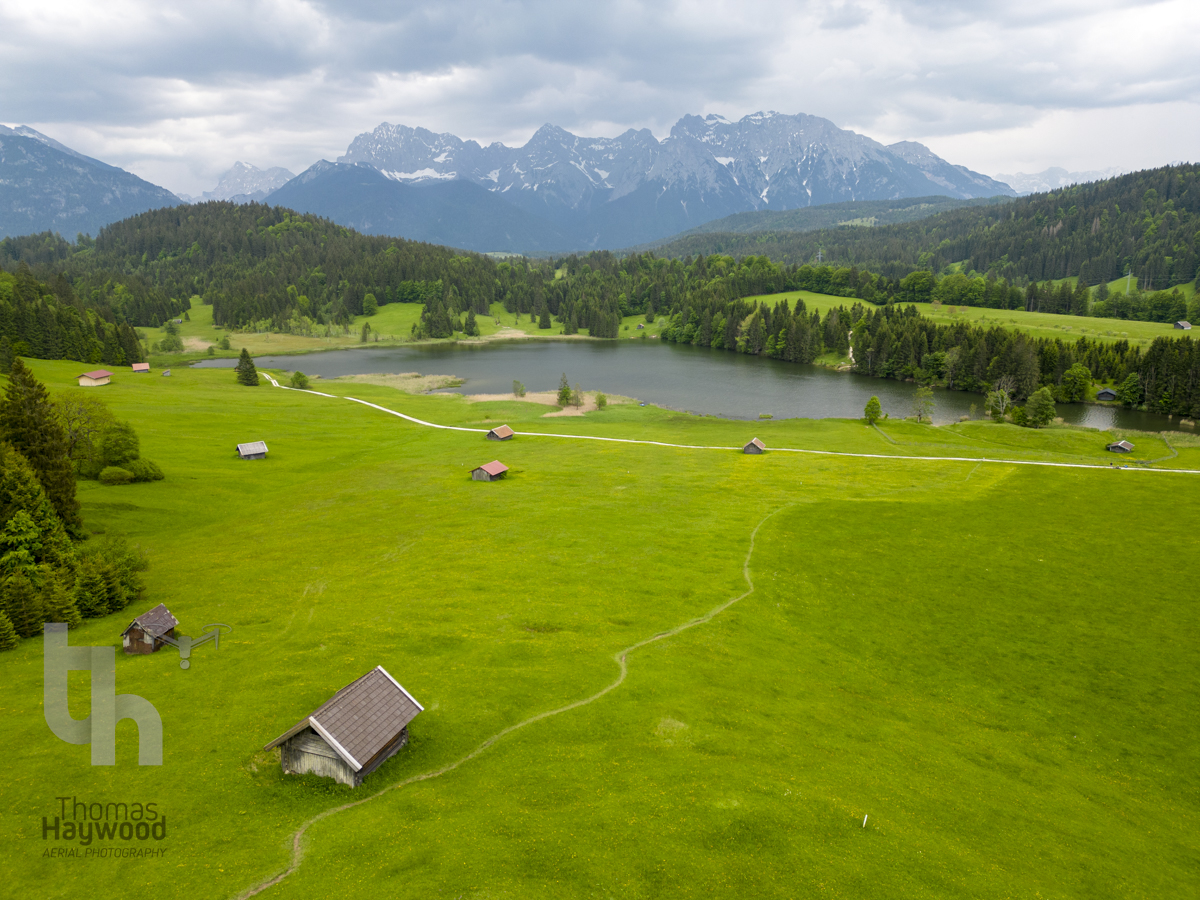 There is no option to take a photo at some locations in cloudy weather other than when you visit due to travel arrangements. Make the best of what you have to compose the photo.  This is Wagenbruchsee,  near Garmisch Partenkirken #aerialphoto #alps #Mountains