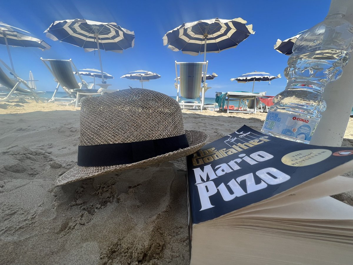 Immersed in the enchanting Italian coastline, where the waves gently whisper and the sun lovingly kisses my skin. My summer hat a loyal companion, and 'The Godfather' an engrossing narrative, completing the picture of a perfect vacation. #SummerInItaly #BeachReads #TheGodfather