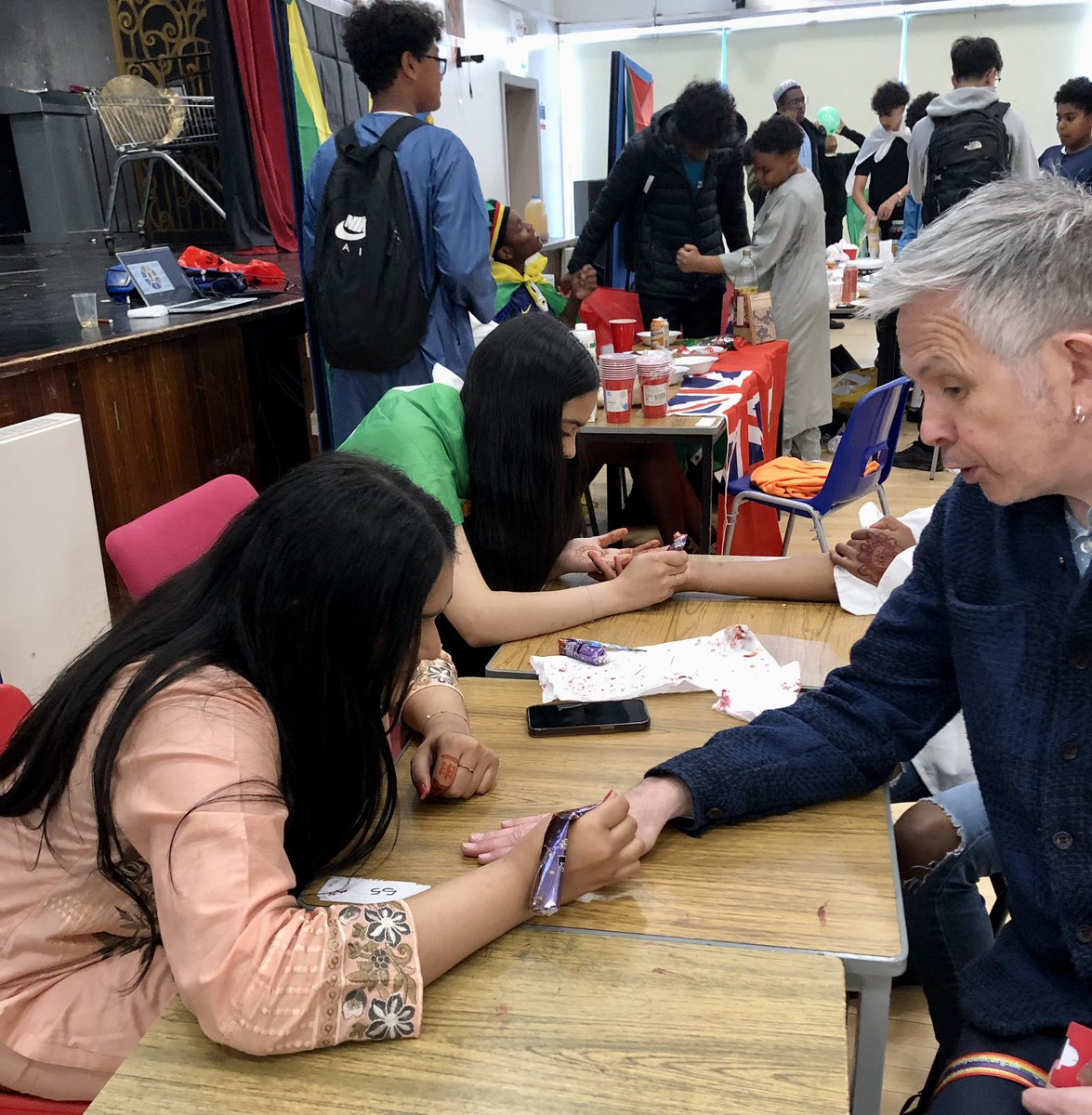 LHS_SfL's tweet photo. Peely-wally Scotsman visibly perked up by fabulous World Fair celebrating our brilliantly diverse school community. Am now full of food from all over the world and covered in henna! Thanks to the brilliant @MrKwakuAdjei for organising with the support of our fabulous pupils!🌏 https://t.co/hwy8Q0H4dB