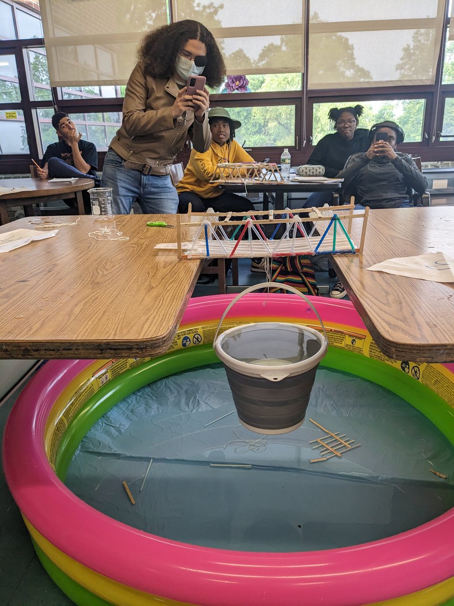 Testing our student designed and built bridge designs today in R&amp;D to determine which structure can bear the most weight. Our winning bridge is below, supporting a bucket of 12,000mL of water!! 1🌊🌉