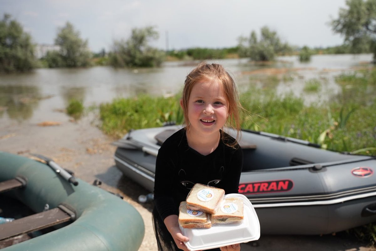 WCKitchen's tweet photo. In the aftermath of the dam flooding in the Kherson region yesterday, WCK is continuing to provide nourishment to families with warm meals &amp; clean water. The water level in the area continues to rise, but the smiles of the kids we get to support keep us going 💙 #ChefsForUkraine https://t.co/hXKeqcuTCD