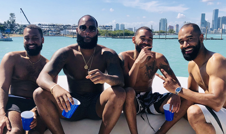 A couple of guys enjoy the sun while renting the Black Ice yacht. #blackiceyacht #miamiyacht