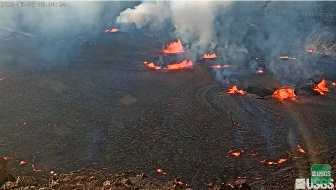 Webcam image of lava in Kilauea crater with rising steam, smoke and ash.