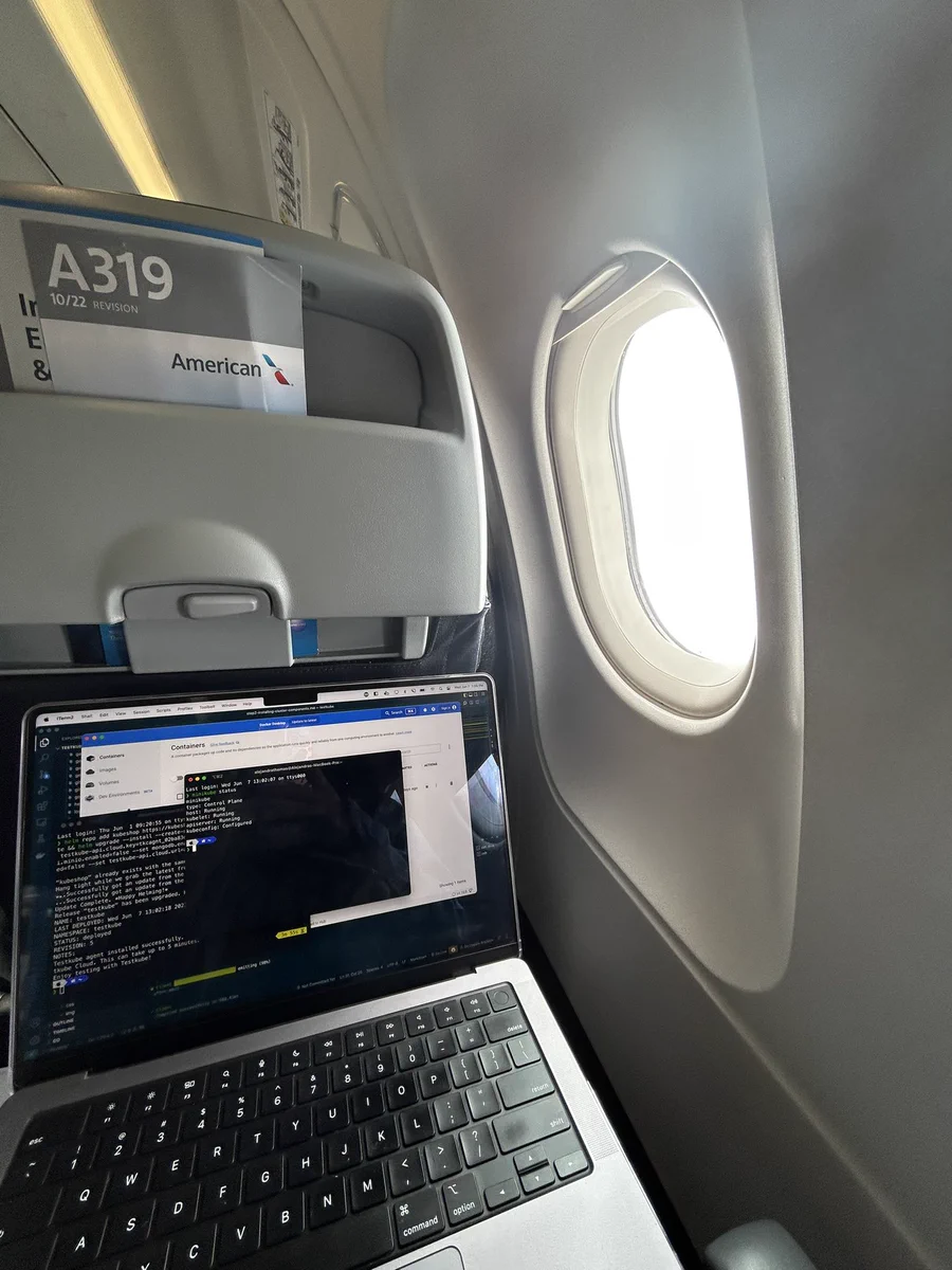 Laptop installing Testkube on a plane while we’re going through a cloud