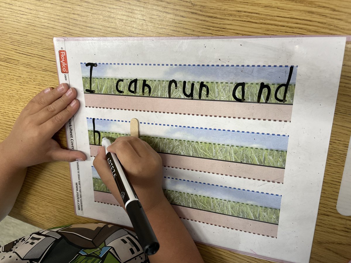 Sentence dictation in #Kindergarten with scaffolding strategies - using a popsicle stick to help with word spacing, and using sky-grass-ground templates to assist with proper print formation.

#StructuredLiteracy 
#EarlyYears 
#EarlyLearning