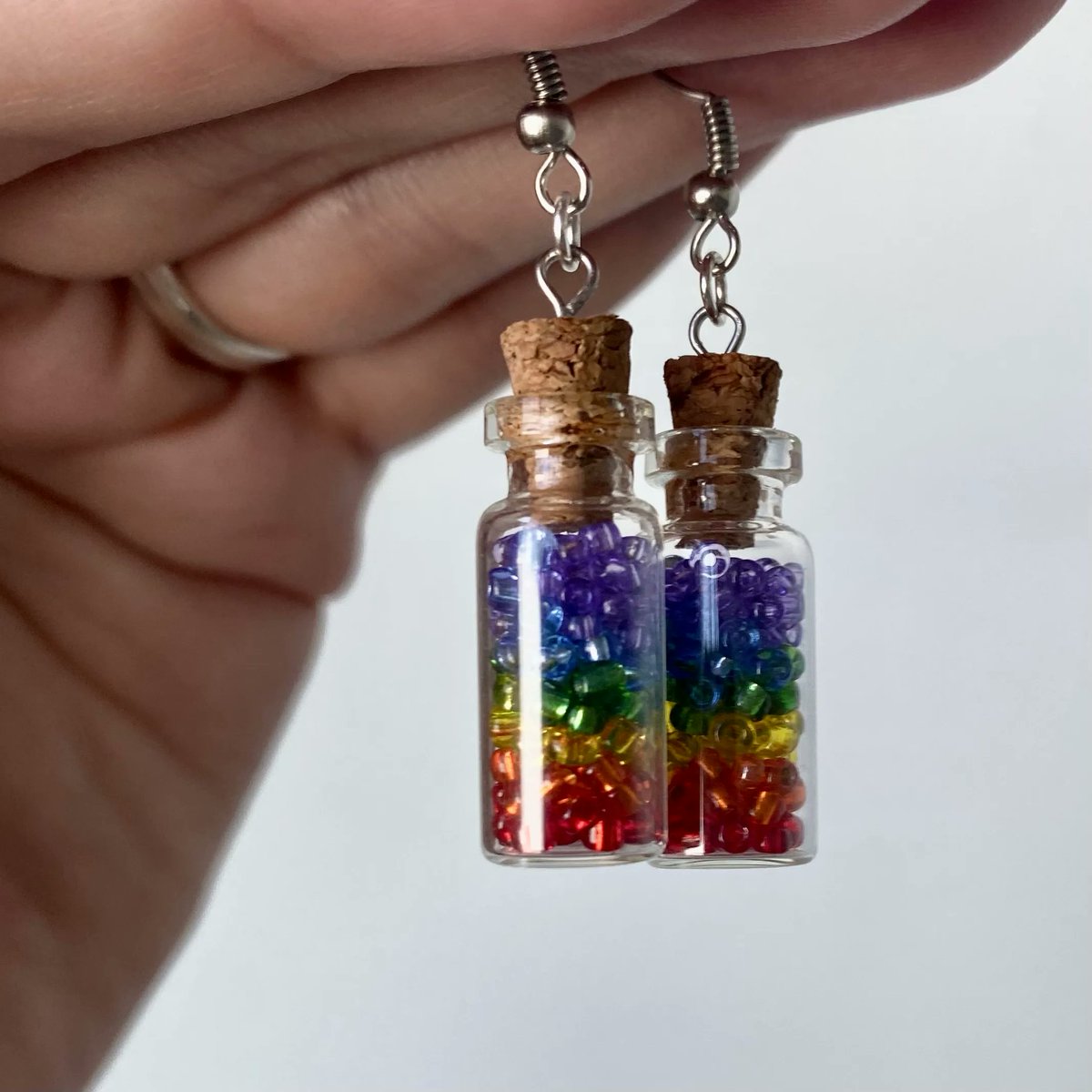 Check out these “Pride in a Bottle” earrings by co-op member <a href="/misstheraart/">Miss Thera</a> - Her shop Atypically Artistic is donating all profits from pride product sales to the #ItGetsBetter project this month. 

Find her shop and more in our member directory. 

#LinkInBio #LGBTQPrideMonth