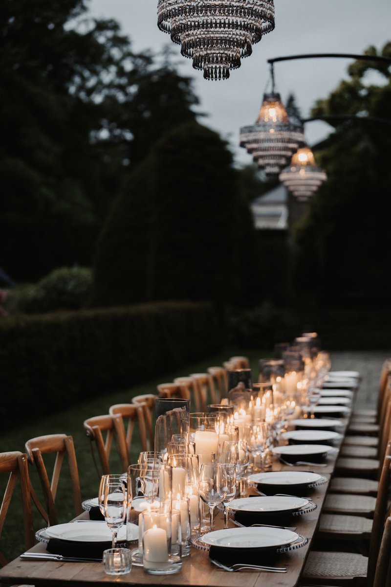 Outdoor wedding breakfast with suspended chandeliers 😍