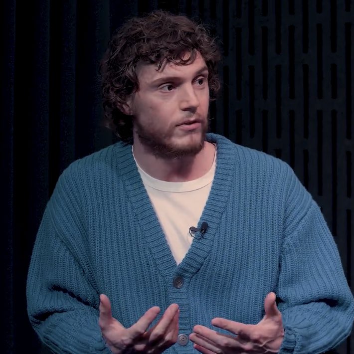 Evan with curly hair and blue cardigan NOT REAL!