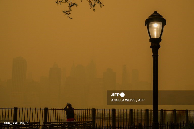 AFPphoto's tweet photo. Canada wildfires shroud New York in apocalyptic haze. #AFP 
📸 @timothyaclary 
📸 @angelaweissfoto https://t.co/dXoGB51aQw
