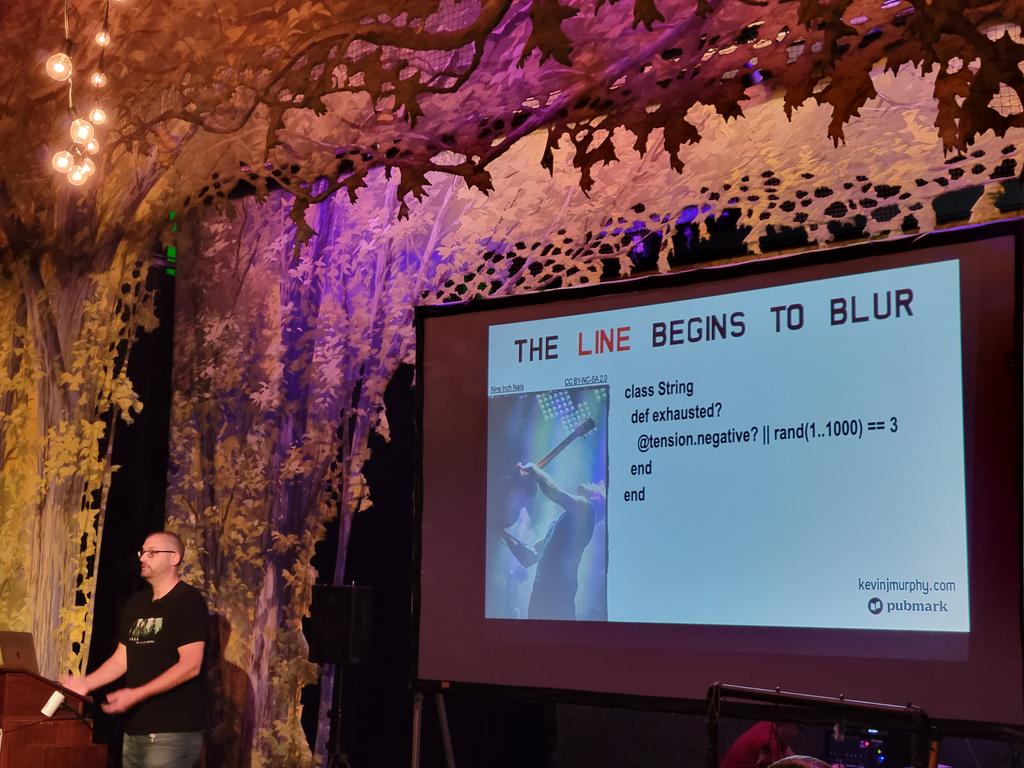 nirvdrum's tweet photo. I'm really enjoying the NIN theme in the #BlueRidgeRuby by @kevin_j_m. He's got the tour shirt on, photos of the band on the slides, and the slide titles are song titles. https://t.co/uaTE0j8uAC