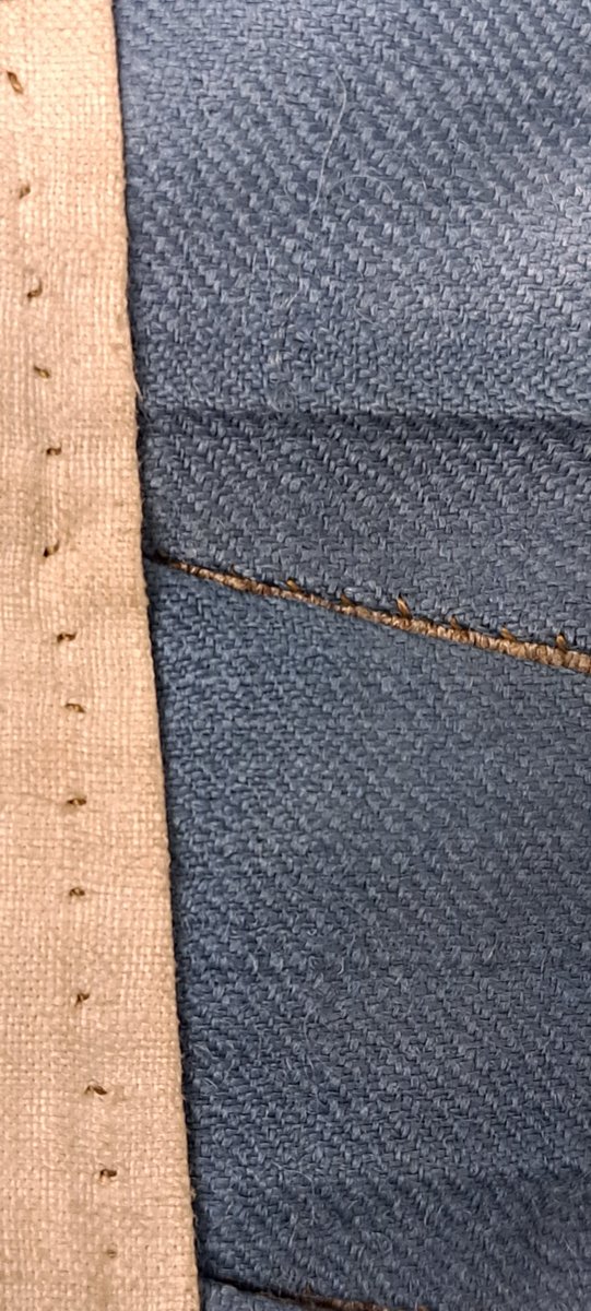 A detail of the lining and facing, the slits are the buttonholes.
