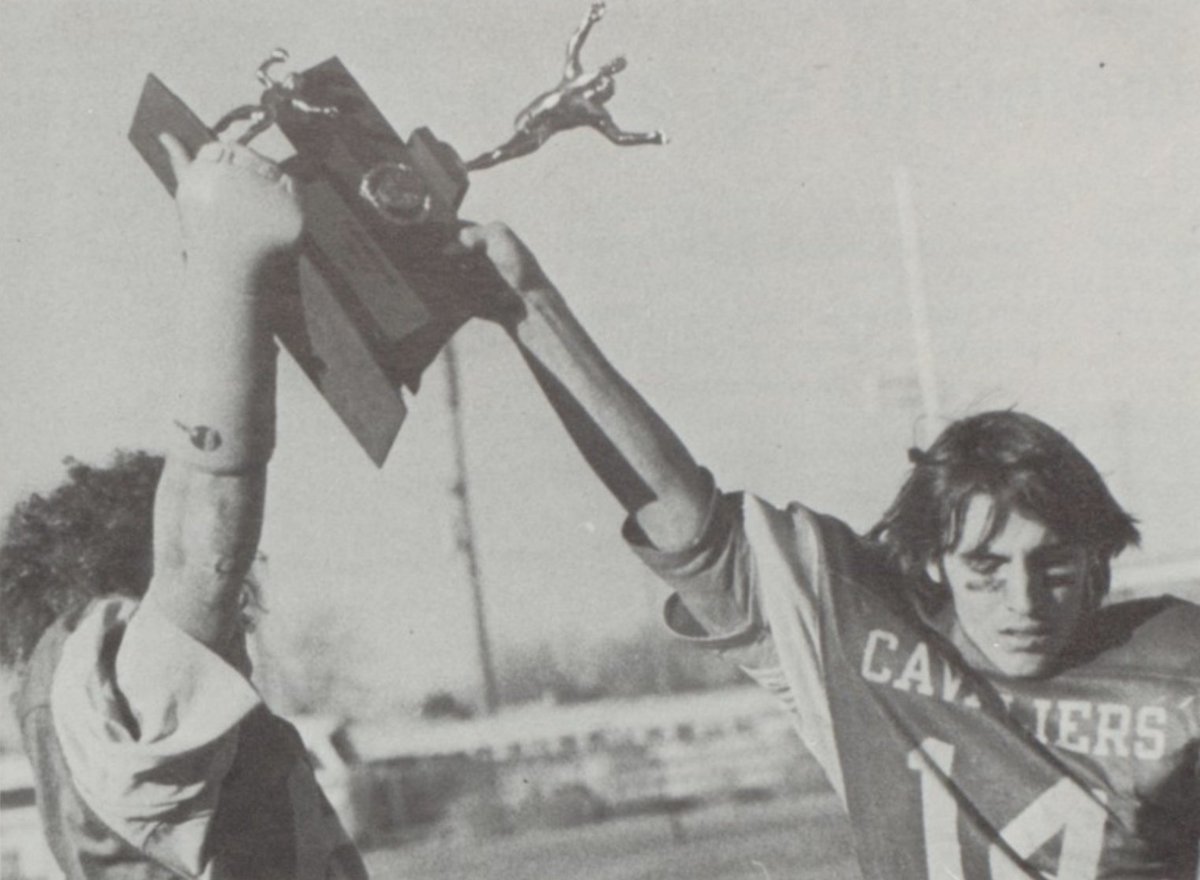 Bishop Neumann all-state QB Doug Lanik hoists the 1975 state title trophy while rockin' #14.