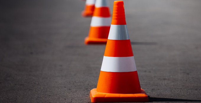 Photo of a traffic cone on a road.