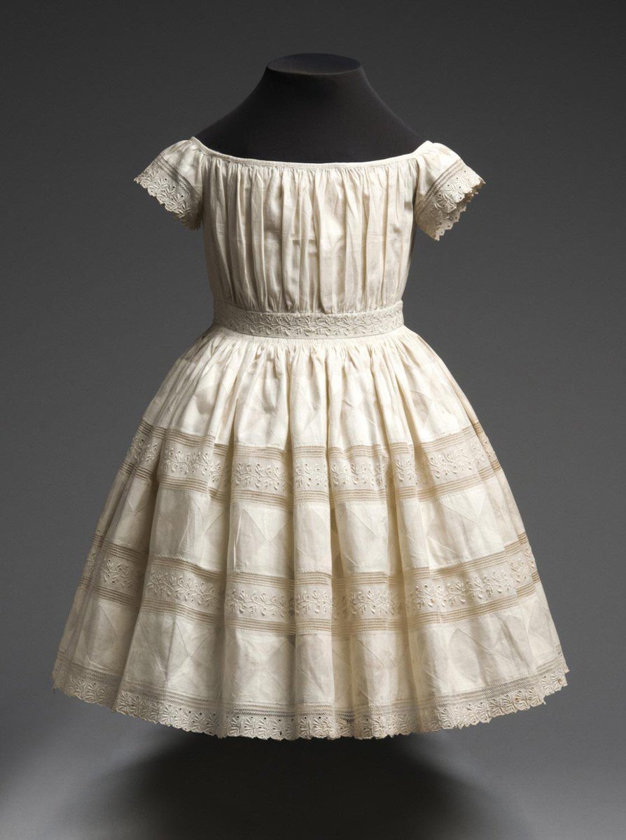 Child's dress, mid- 19th century. Cotton plain weave, cotton/linen plain weave reverse appliqué, cotton lace. United States. Philadelphia Museum of Art.