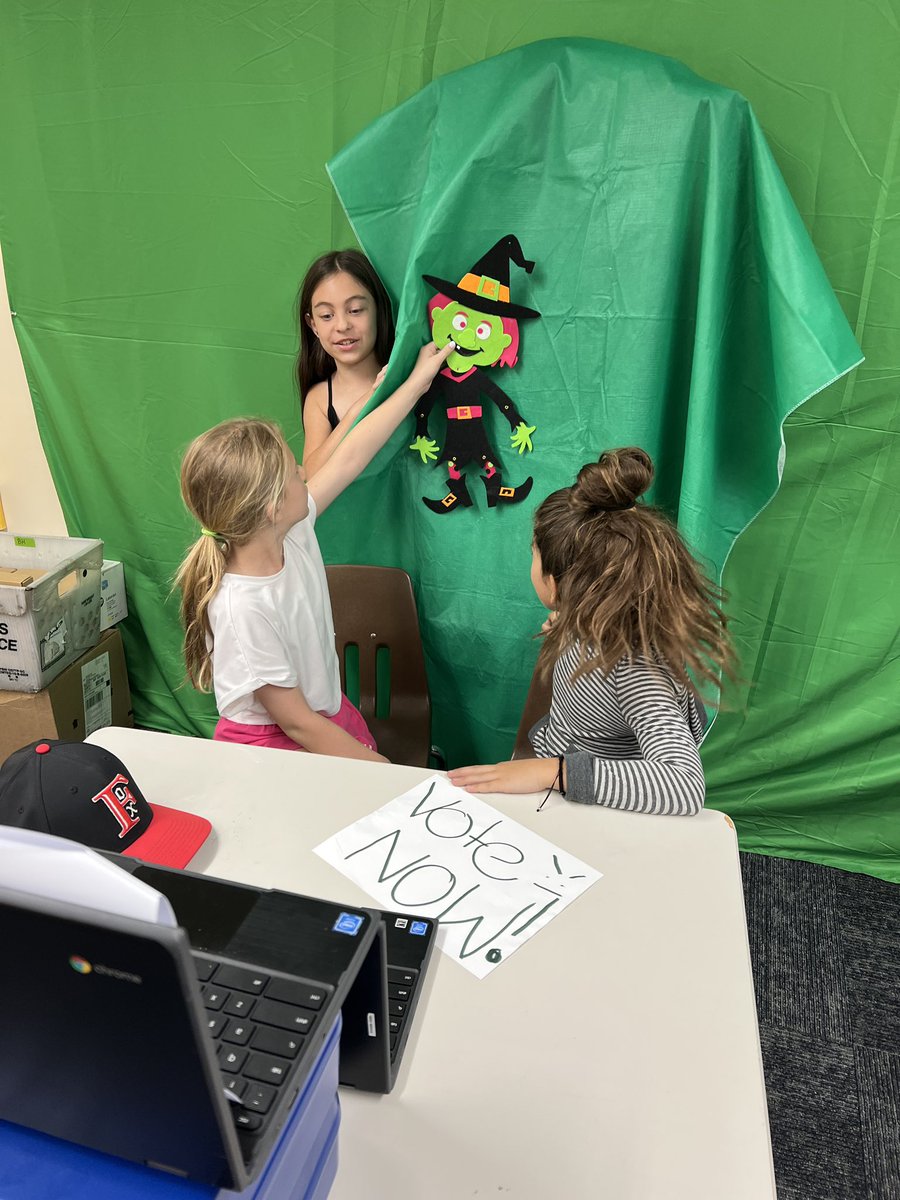 DrBurke_EdTech's tweet photo. Students in BHES 3H shooting a @WeVideo with green screen for a student news pilot. I love that THEY problem solved how to make the witch move across the background by using this green tablecloth and hiding behind it! #ActiveConnectedLearning @BCSDNOTES https://t.co/u1ZX7TQ5PO