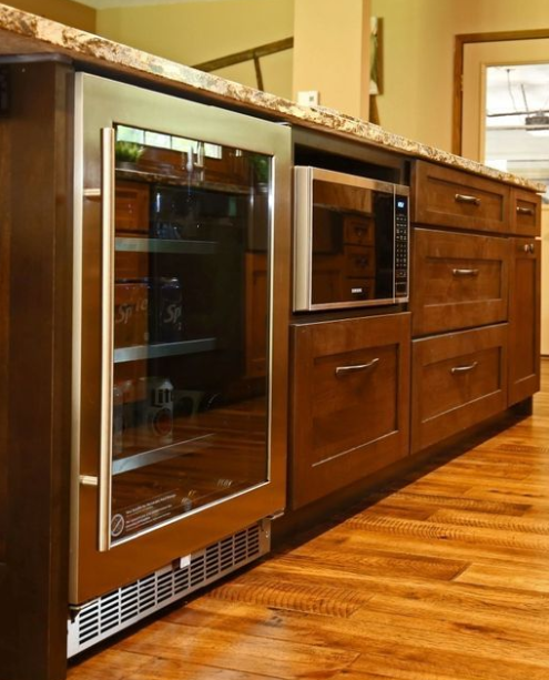 The popularity of appliances placed under the counter is growing. It keeps your counters clean and utilizes the space efficiently. This island showcases this convenience in a perfect way.