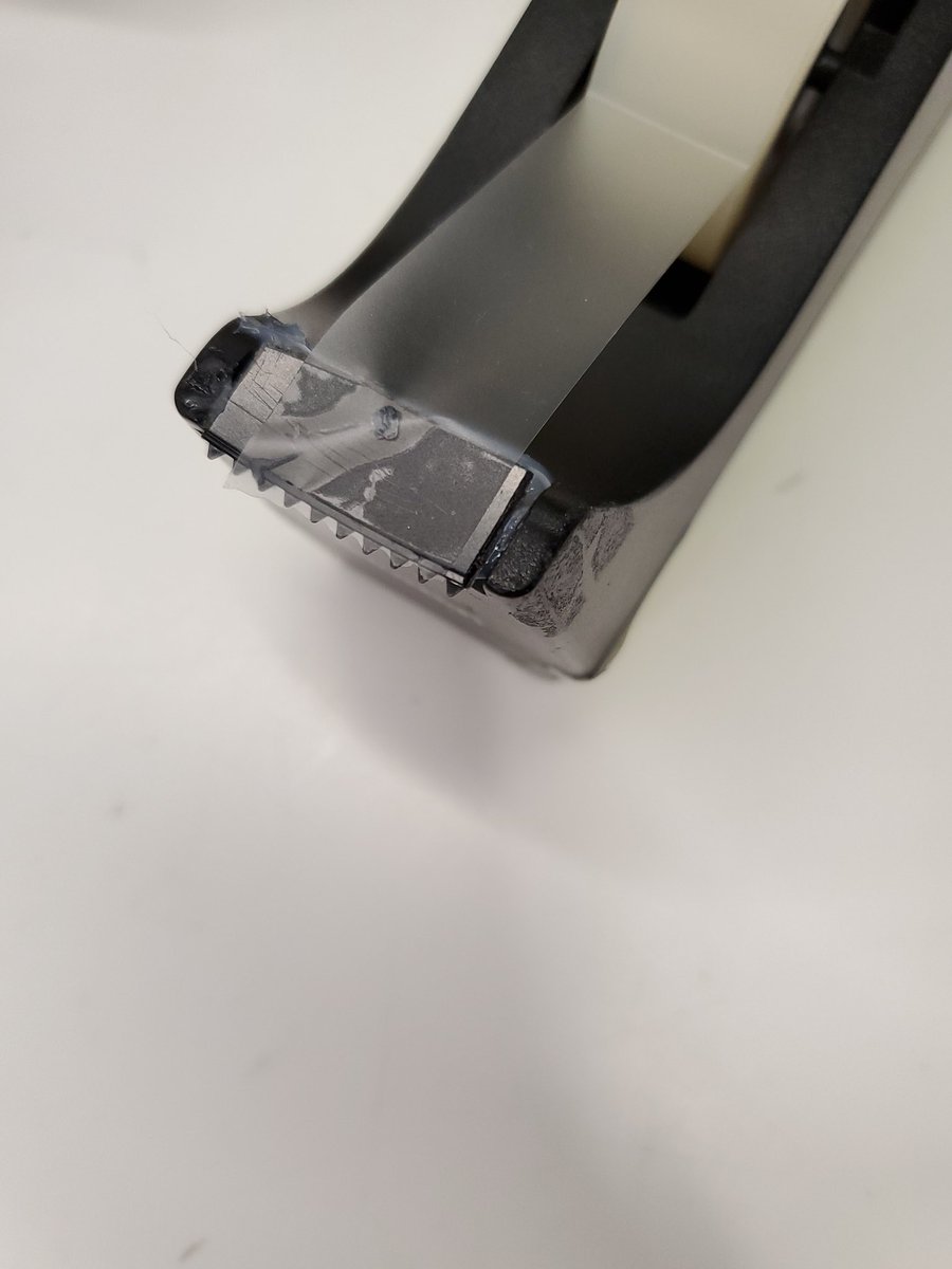 DrTLovesBooks's tweet photo. Someone dropped the tape dispenser, snapped off & lost the little metal serrated bit that cuts the tape.
But never fear! Some hot glue and a piece of plastic cafeteria knife to the rescue!
#MakerFriday 😂 https://t.co/XNHDkB0Lgs
