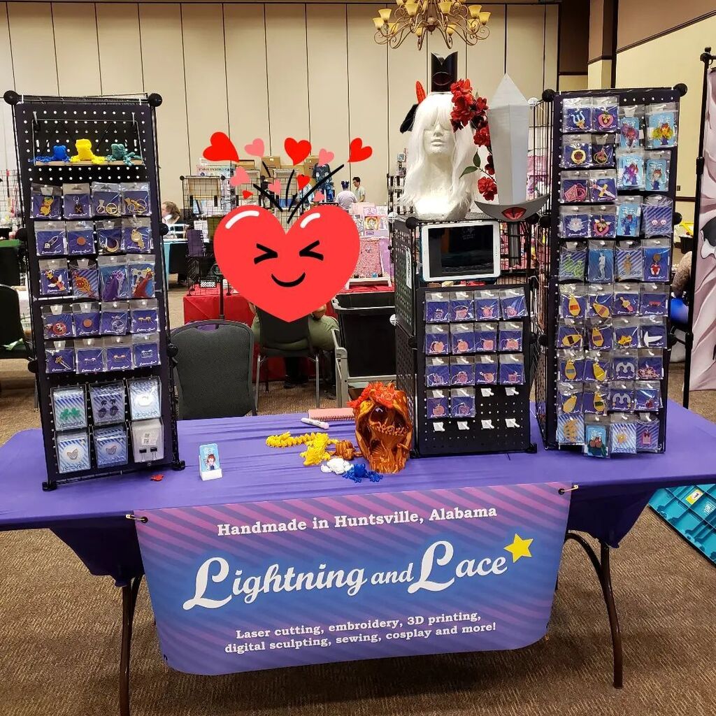 lightning_lace's tweet photo. All set up at @rocketcityanimecon today! Surprised but thrilled with the 8-foot table. I'm going to have to grab some more things from the studio! 🥰🤣 https://t.co/dWDuNjHNN4 https://t.co/3Y8tamsWIV