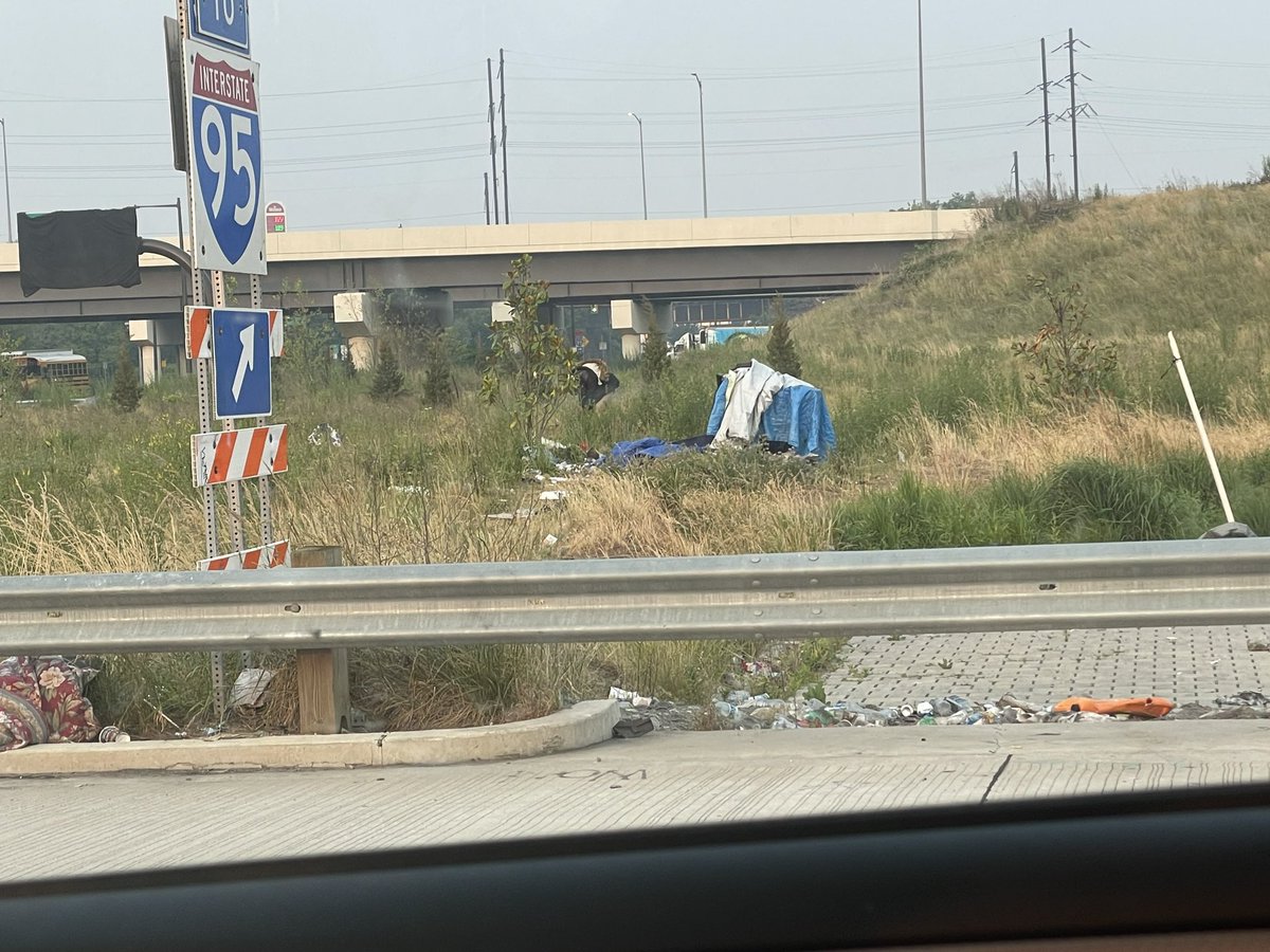 RutkowskiNathan's tweet image. I claim the space between the I95 sign and the encampment as a work of art #conceptualism #dematerialization