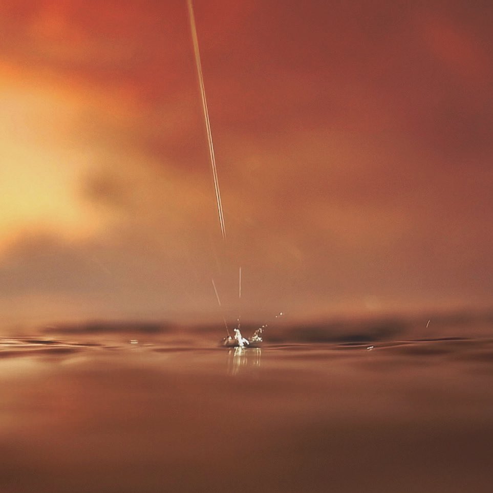 A single rain drop falls and fuses with the expanse of the sea.