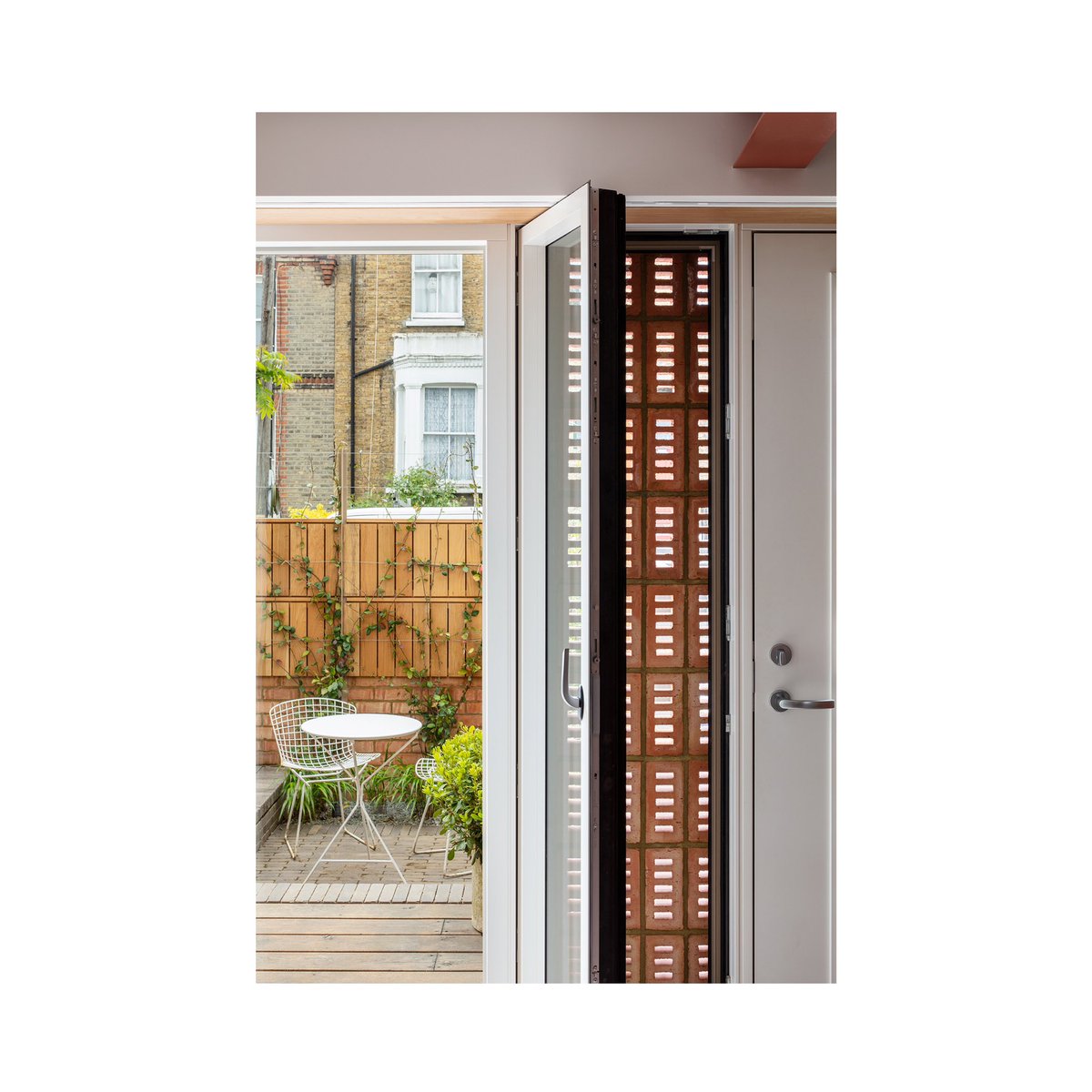 Perforated House / A careful retrofit of an unloved 1960s dwelling. New perforated brickwork is carefully layered with glazing to provide screened openings and therefore secure ventilation so that the building can always breathe. 📸 by The Modern House &amp; Marcus Peel