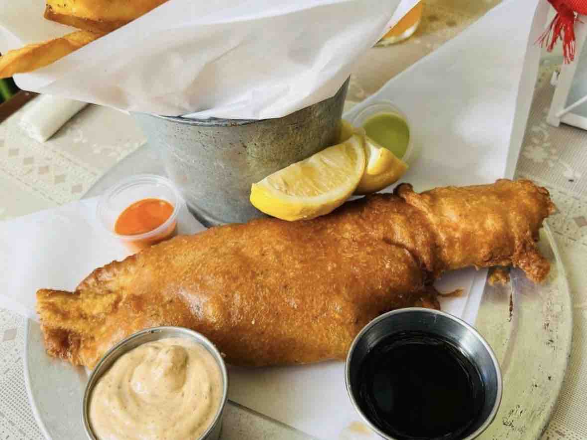 queenstownph's tweet photo. Satisfy your seafood cravings with our Fish &amp; Chips - crispy beer-battered haddock with a side of tartar sauce. It’s the ultimate comfort food! #FishandChips #NZEats #QueenstownEats #LittleItalySanDiego https://t.co/3T0WtQc32S