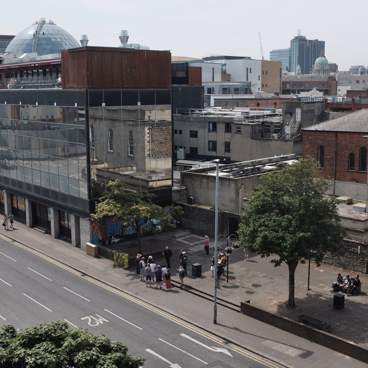 JohnJBaucher's tweet photo. Spot the window cleaner. City looking good today @donzo68 from @DCToursBelfast in full flow, audience in rapture including a trio of local residents enjoying a restorative lucazade earwigging too. @VaultArtistsNI #Belfast #city #viewfromthestudio #newproject? #settlingin https://t.co/brJiF9vJ80