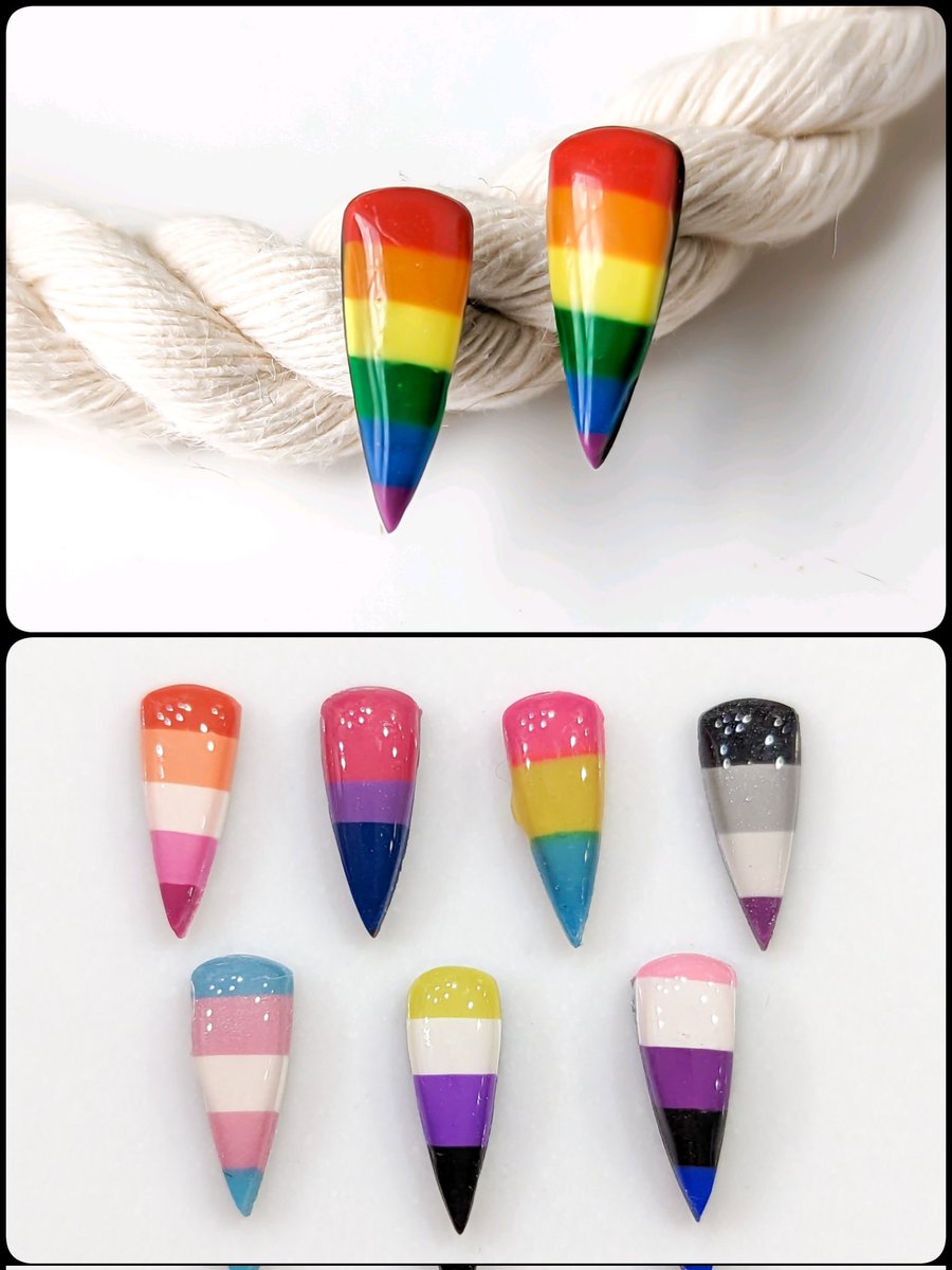 LEFKDesigns's tweet photo. Pride dagger studs now come with 8 flag options: rainbow, lesbian, bi, pan, ace, trans, nonbinary, &amp; gender fluid.

Each pair will be made to order using titanium posts, and every pride collection purchase this month will see 1/4 of its profits go to the Trans Advocacy Network. https://t.co/WfiClgJU24
