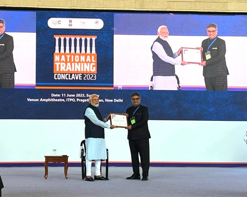 Hon'ble PM presented the certificate of CBC accreditation to Shri Sanjay Puri, Pr. DG (Training), NADT at the National Training Conclave 2023