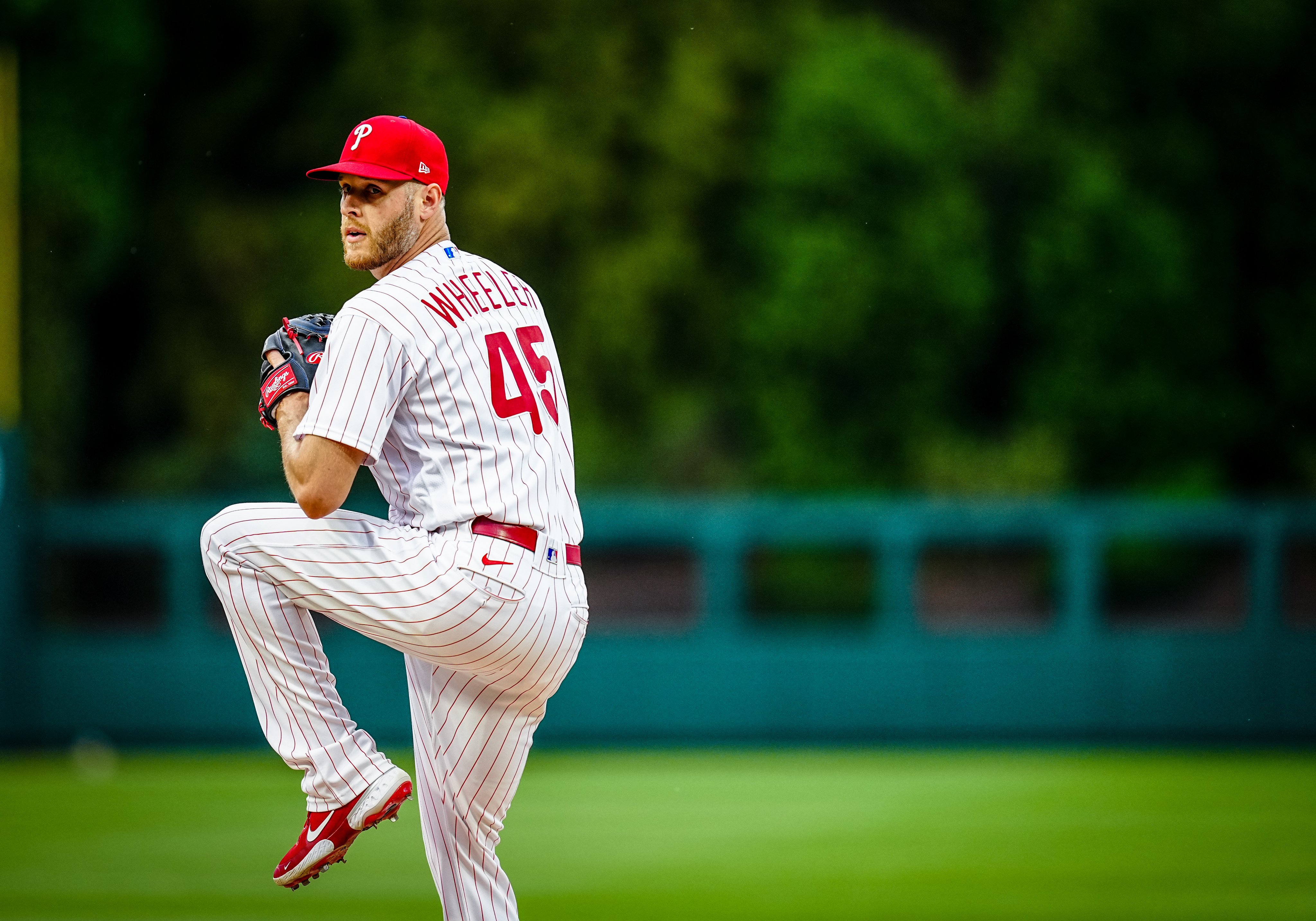 Philadelphia Phillies - Zack Wheeler, wearing the red pinstripe uniform,  about to throw a pitch.
