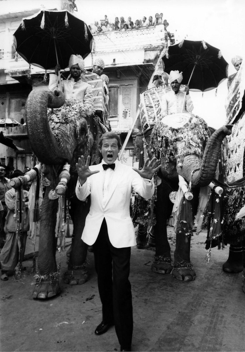 One more for #Octopussy 40th - A behind the scenes colourised pic - Roger leading the charge with his elephant army! #bond #jamesbond #rogermoore #deoldify #bondtwitter