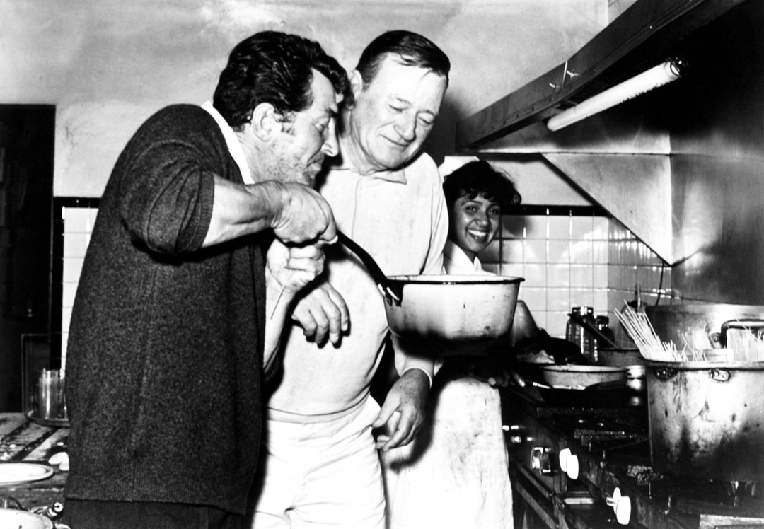 #JohnWayne #DeanMartin cooking spaghetti while on a break from filming 'The Sons of Katie Elder'. 
(New Year's Day 1965)