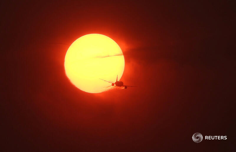 reuterspictures's tweet photo. A commercial plane flies past a sun made dark orange by smoke from wildfires in Canada, as seen from Washington. More photos of the week: https://t.co/2Hpxbyi13K 📷 @LeahMillis https://t.co/WoC0hmxoZ2