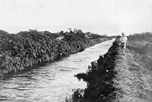 Somaliland Canal 1930S A man in a pith helmet walks along a canal in Somaliland during the British Protectorate period. Date: early 1930s