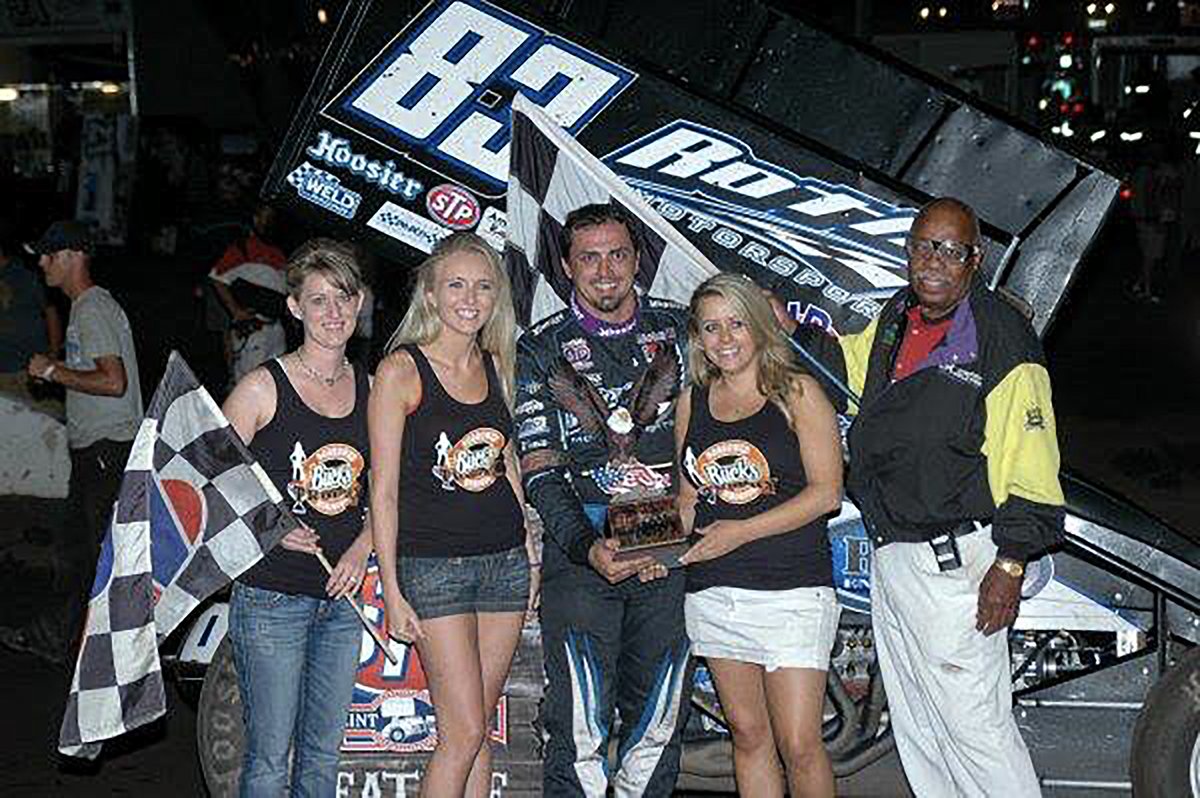 Sunday, June 23, 2013 - Huset's Speedway - Tim Kaeding #83 in victory lane after winning the 410 main event. Driver Tim Kaeding is in the middle, and flagman Doug Clark is on the right. (Goose photo)