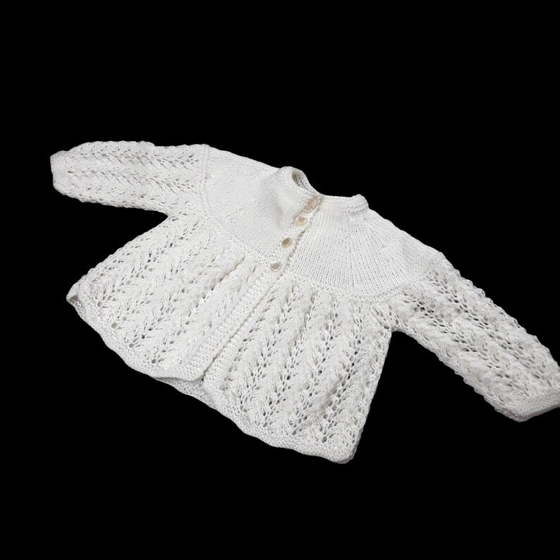 Soft cream baby cardigan with pretty lacy detail hand knitted in lightweight yarn to fit 3 - 6 months buff.ly/42sFQ5o #knittingtopia #etsy #uksmallbiz #handmade #knittedbabyclothes #knitwear #baby #mummybloggers #ukhashtags #MHHSBD #craftbizparty