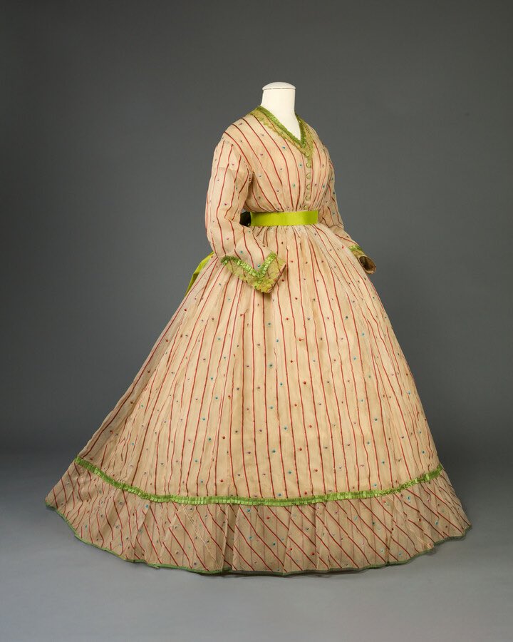 kateStrasdin's tweet image. The gauzy, open weave fabrics so popular in the mid #c19th fascinate me. They could be complex textiles with additional motifs woven in or a textured finish &amp;amp; often had brighter solid trims to off set the sheer cloth. This late #1860s example went bold in acid green @MDHistory