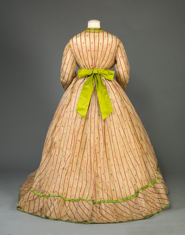kateStrasdin's tweet image. The gauzy, open weave fabrics so popular in the mid #c19th fascinate me. They could be complex textiles with additional motifs woven in or a textured finish &amp;amp; often had brighter solid trims to off set the sheer cloth. This late #1860s example went bold in acid green @MDHistory