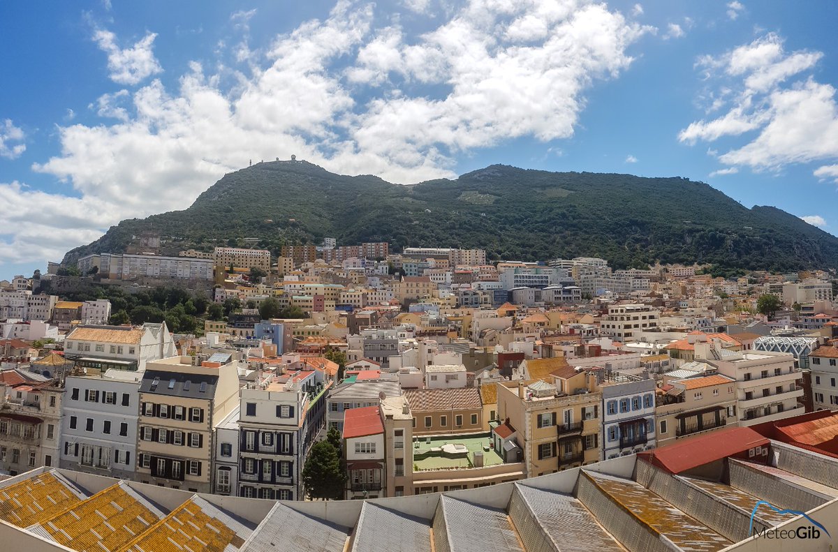 cluck_i's tweet image. #Gibraltar #City #Rooftops - 13/06 - as forecast, low cloud has been coming and going through the morning, with a little still lingering, but more sunshine developing - at 1pm, the temperature is now 25C, in a moderate to fresh West-Southwesterly breeze.