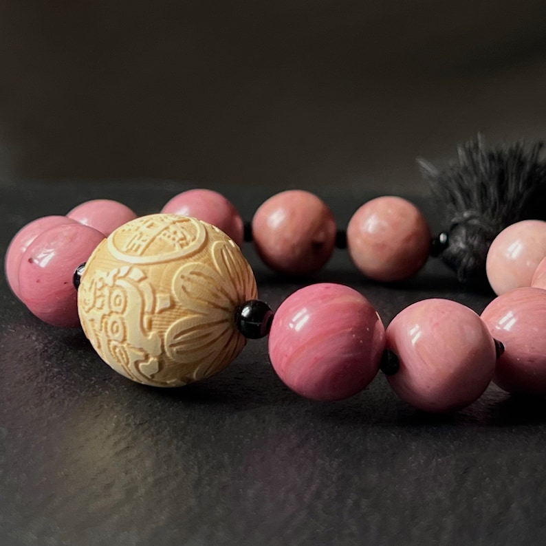 Check out this stunning Handmade Boho Stretch Bracelet featuring Natural Rhodonite and a Black Hemp Tassel. It's the perfect accessory to add a touch of bohemian flair to any outfit! labyswitzerland.etsy.com
 #handmadejewelry #bohobracelet #rhodonite #bohostyle