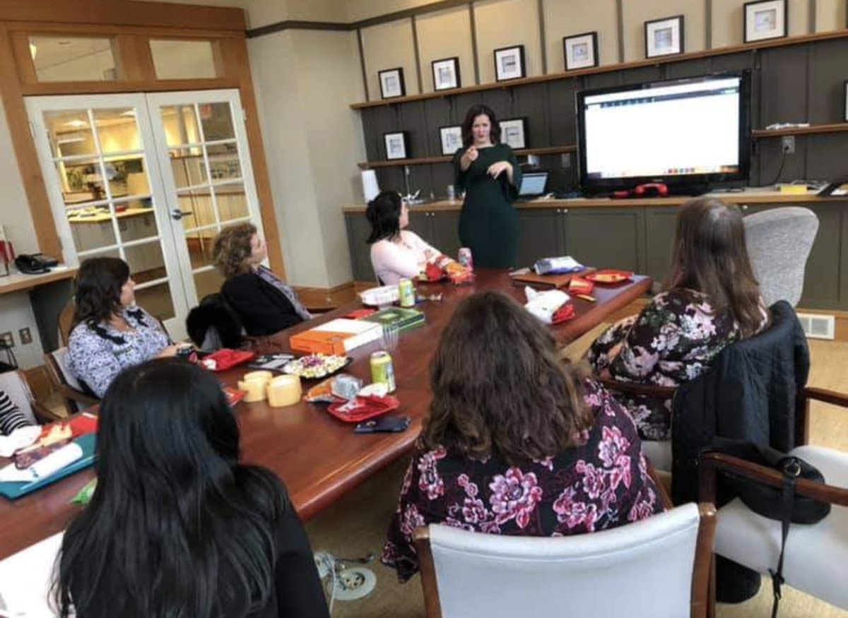 Drop a cool photo of you doing your job! 

Presenting to a new potential social client and securing the account.