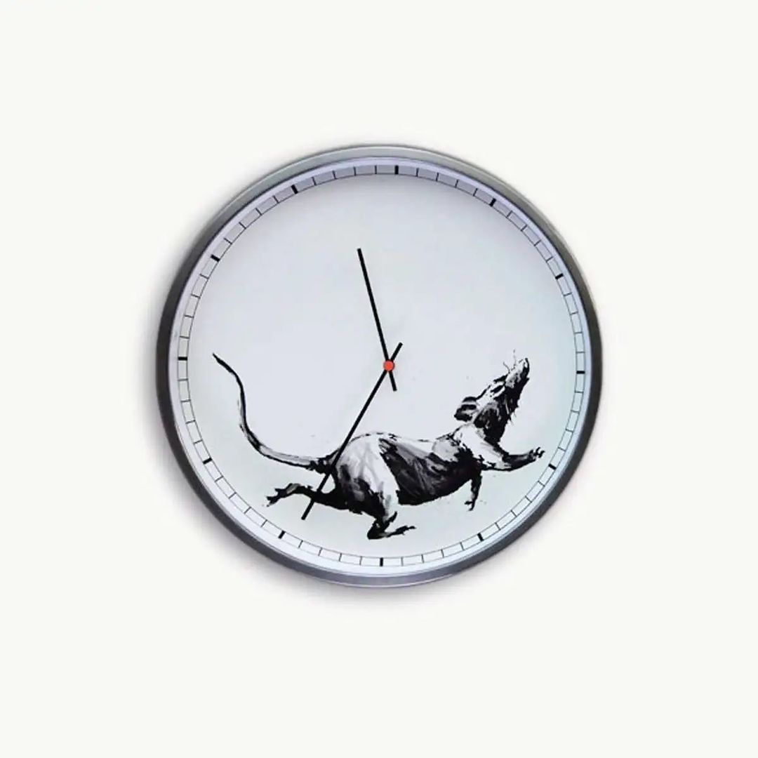 Street art king <a href="/banksy/">Banksy</a> 2019 Clock, features a rat running up the side of the clock face, symbolizing the rat race we find ourselves in, or in the website’s words “to accurately mark our relentless and steady ticking towards the great unknown”.

Credit My Art Broker