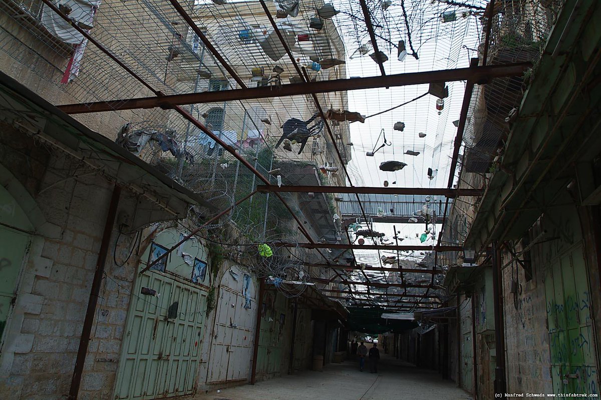 Mondoweiss's tweet photo. That looks fun! Here's a photo of the fencing Palestinians in the occupied city of Hebron had to install to catch the garbage Israeli settlers throw onto them from the second floors they have illegally moved into. https://t.co/n70gb1kSuh