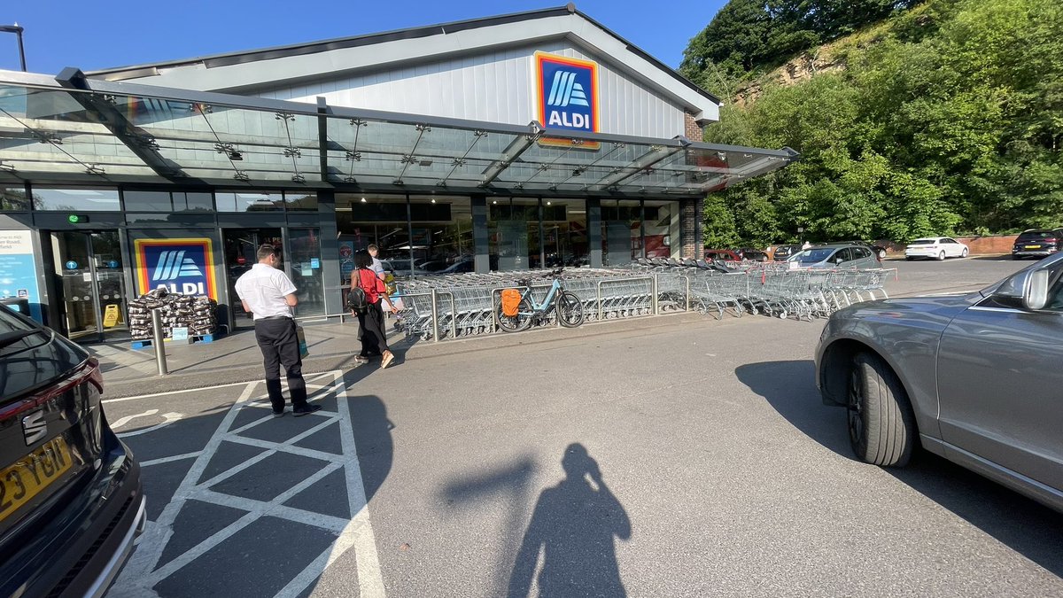 PeterPoddy's tweet photo. Still no bike parking at my local store @AldiUK it’s difficult to get a lock round the trolley bay rails but that’s all there is. https://t.co/JQ7JJXmKx6
