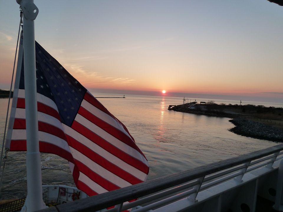 CMLFerry's tweet photo. Did you know... The American Flag was adopted on June 14th, 1777. In honor of Flag Day today, here are a few of our favorite shots of the flag flying from the Ferry over the years. #FlagDay #FerryFan https://t.co/3kBM5KLFYx