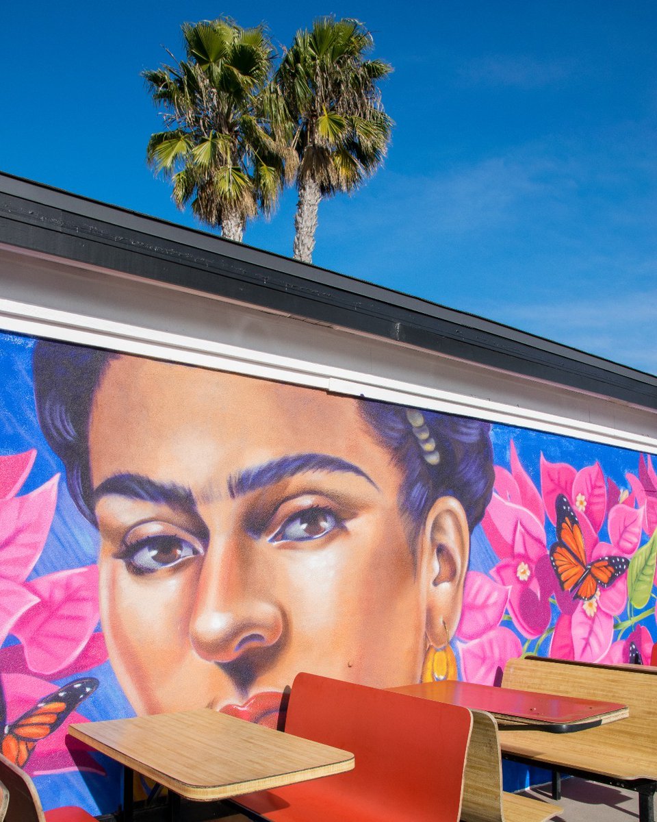 Vibrant art is just around the corner in Oceanside. 🦋 Do you know where you can find this Frida mural in O'side? 🌺