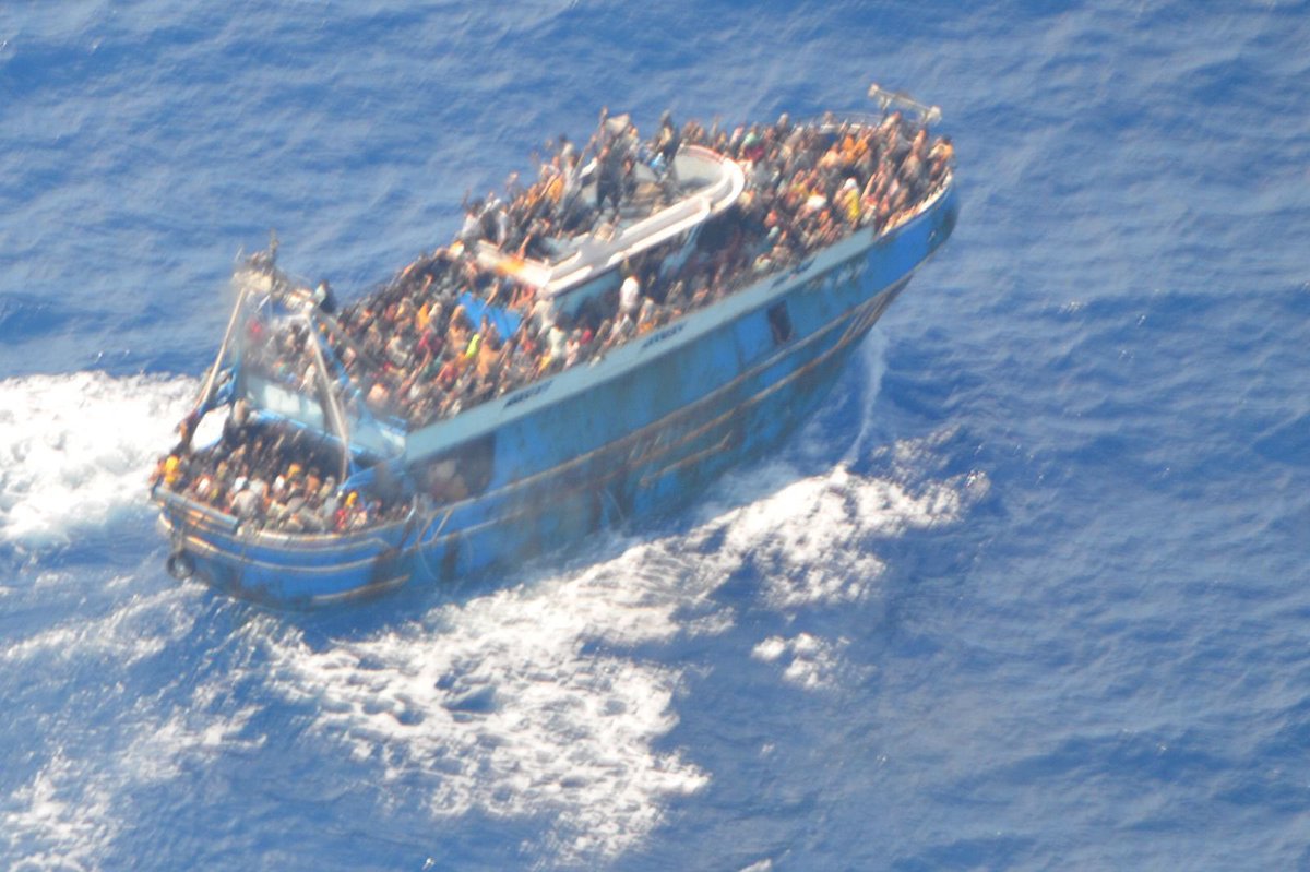 Photos of migrant boat taken by Greek coast guard helicopter on Tuesday indicates hundreds were aboard. Official death toll so far 79 with 104 survivors. Shipping Ministry official says boat sunk in spot where sea is 4,000 meters deep so retrieving other victims may be impossible