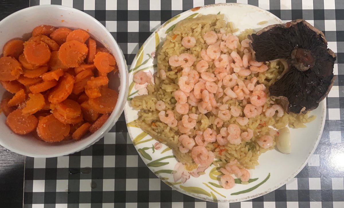 Bowl of carrots, vegetable rice, tiny shrimps, portobello mushroom cap with chipotle sauce
